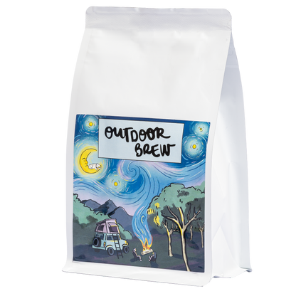 White coffee bag with 'Outdoor Brew' label featuring a night sky and camping scene on a white background